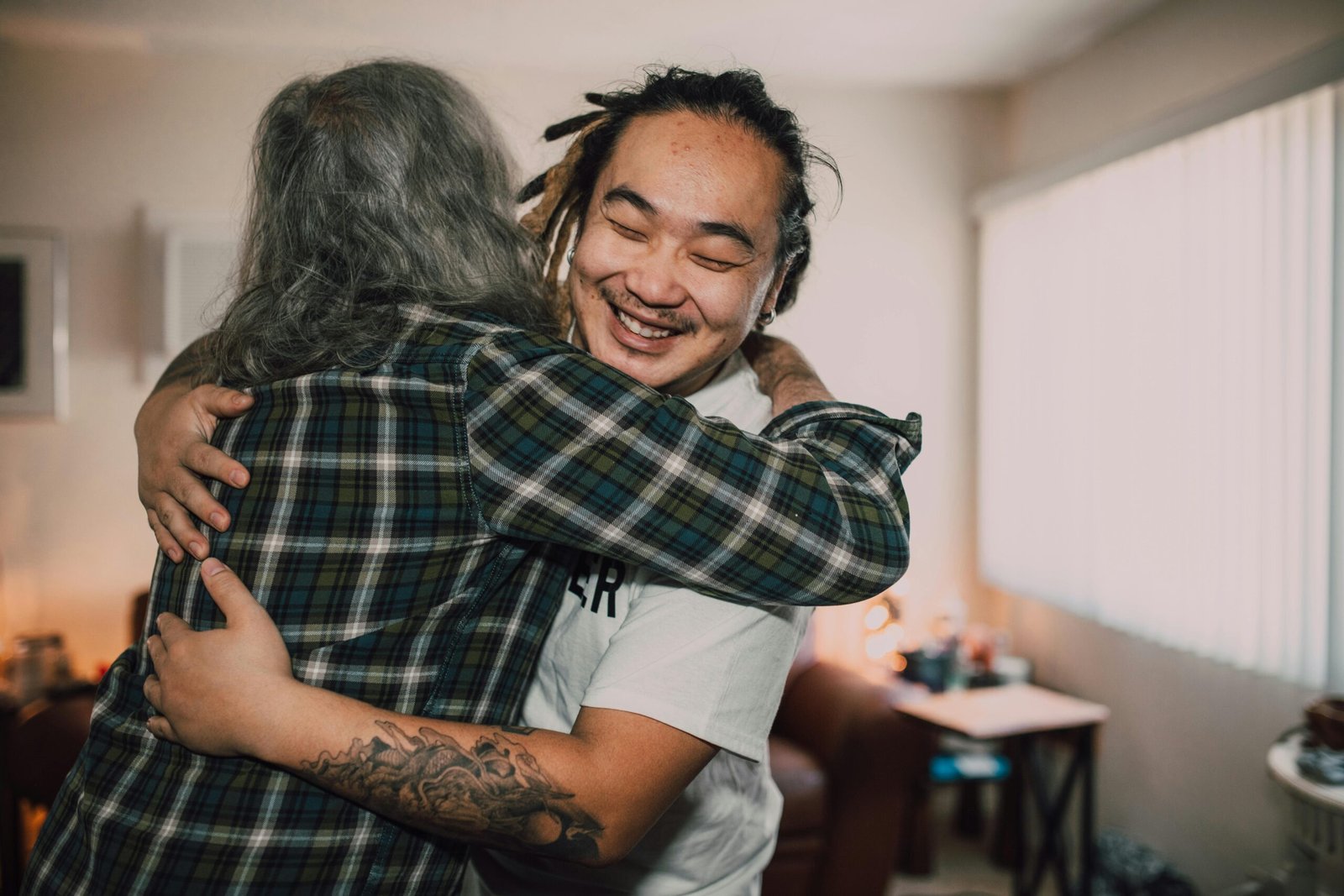 A joyful hug between friends in a cozy room, capturing warmth and friendship.